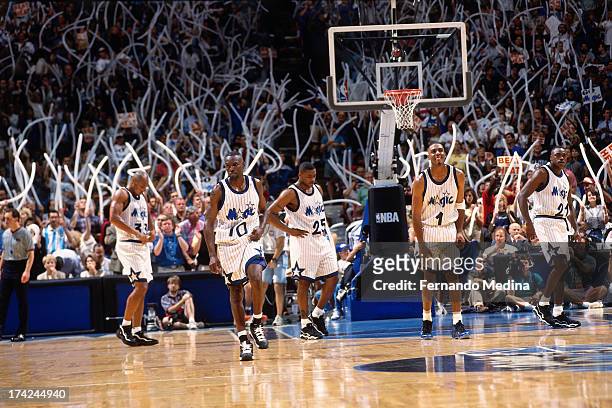 Derek Strong, Darrell Armstrong, Nick Anderson, Anfernee Hardaway, and Gerald Wilkins of the Orlando Magic wait to resume play against the Miami Heat...