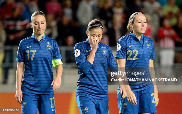 France's players react after losing in the penalty shootout of the UEFA Women's European Championship Euro 2013 quarter final football match France...