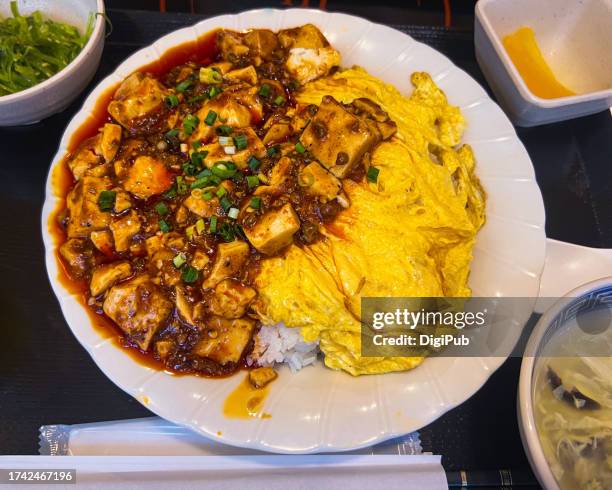 mapo tofu and fried egg over rice - takuan stock pictures, royalty-free photos & images