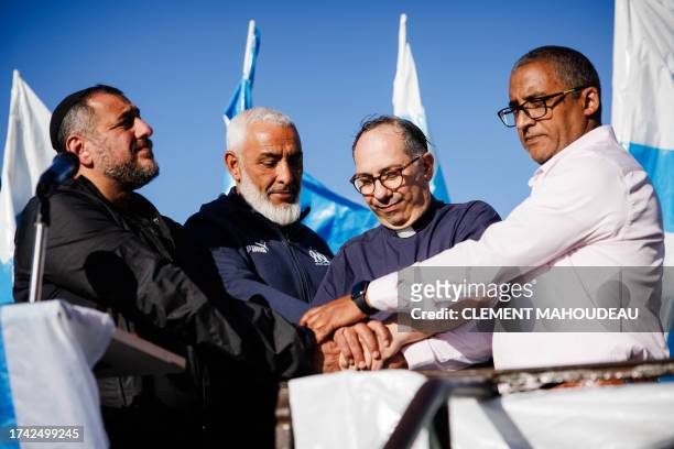 Rabbi Haim Bendao , Rachid Zeroual, leader of the Olympique de Marseille South Winners fan club priest Olivier Spinosa , and Imam Hassan Rajii , hold...