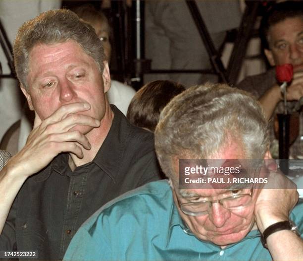 President Bill Clinton and DNC General Chairman Colorado Governor Roy Romer listen as they are introduced during a DNC luncheon 01 November at the...