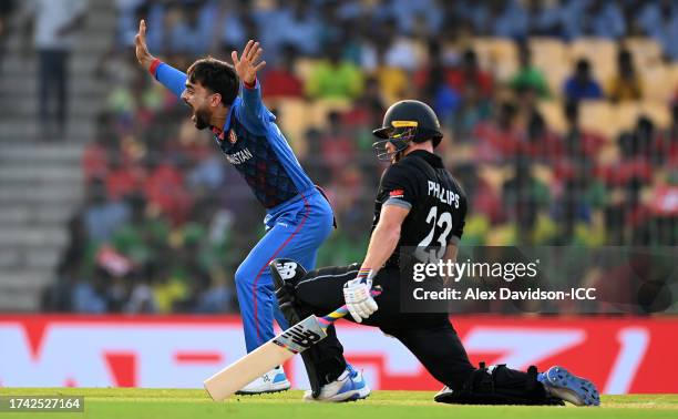 Rashid Khan of Afghanistan unsuccessfully appeals for the LBW of Glenn Phillips of New Zealand during the ICC Men's Cricket World Cup India 2023...