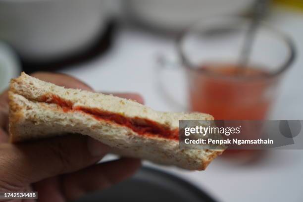 whole wheat bread with peanut butter jam and juice - peanut butter and jelly sandwich on plate stock pictures, royalty-free photos & images