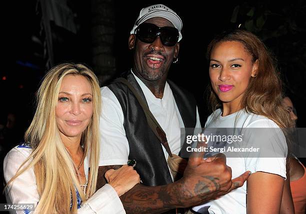 Lisa Pliner, Dennis Rodman, and Alexis Rodman attend the Minimale Animale show during Mercedes-Benz Fashion Week Swim 2014 at Oasis at the Raleigh on...