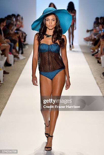 Model walks the runway at the Caitlin Kelly Swimwear show at Cabana Grande at the Raleigh on July 22, 2013 in Miami, Florida.
