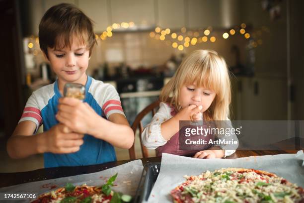 children making pizza at the kitchen - children cooking school stock pictures, royalty-free photos & images