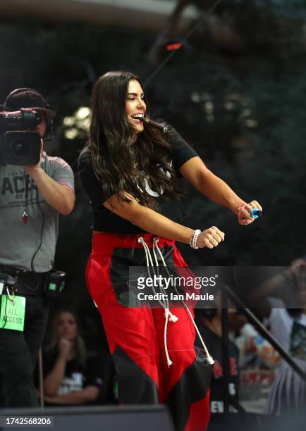 Kelsey Plum of the Las Vegas Aces walks across the stage during the 2023 WNBA championship victory parade and rally on the Las Vegas Strip on October...