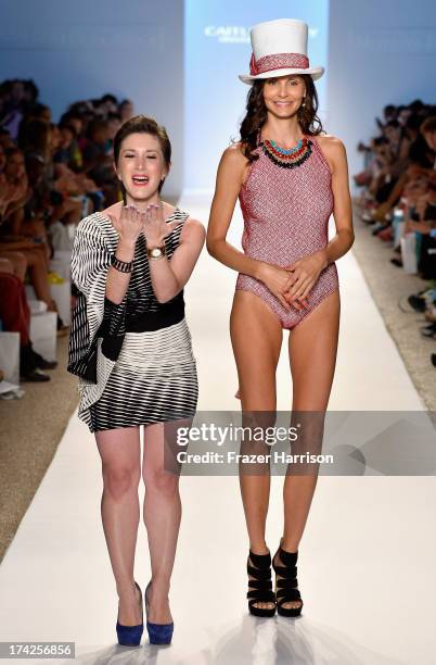 Designer Caitlin Kelly and a model walk the runway at the Caitlin Kelly Swimwear show at Cabana Grande at the Raleigh on July 22, 2013 in Miami,...