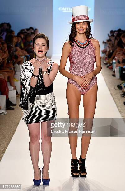Designer Caitlin Kelly and a model walk the runway at the Caitlin Kelly Swimwear show during Mercedes-Benz Fashion Week Swim 2014 at the Raleigh on...