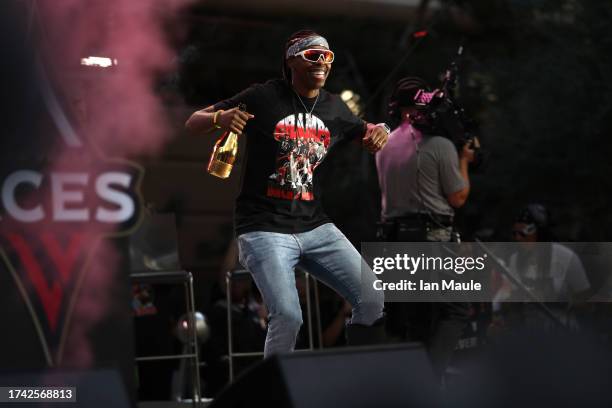 Chelsea Gray of the Las Vegas Aces dances on the stage during the 2023 WNBA championship victory parade and rally on the Las Vegas Strip on October...