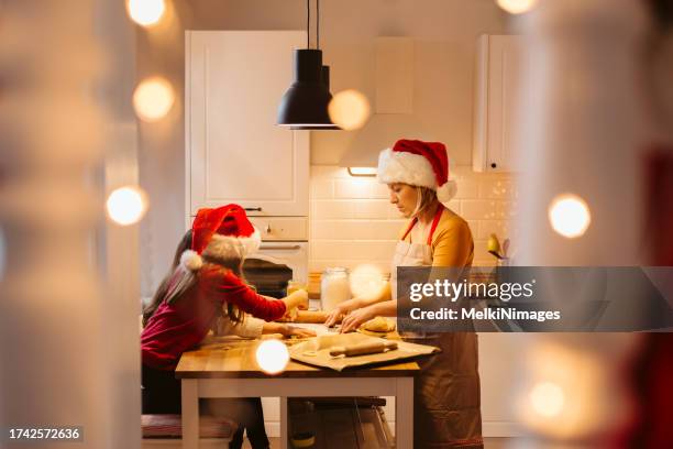 mother and children making christmas cookies in the kitchen - baking pan stock pictures, royalty-free photos & images