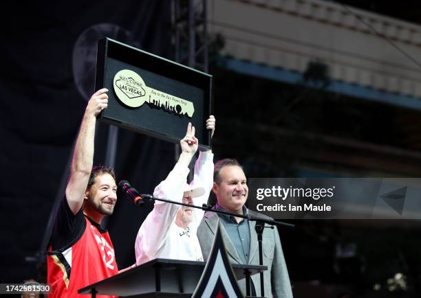 Las Vegas Aces owner Mark Davis is presented with a ceremonial key to the city of Las Vegas by Clark County Commissioners Michael Naft and Ross...