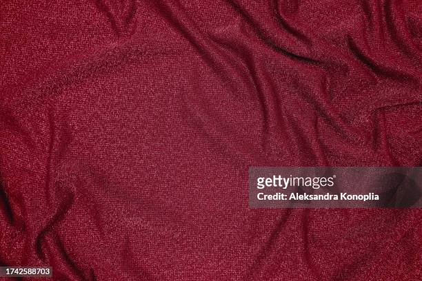 trendy 80s, 90s, 2000s background of draped dark red fabric with silver lurex thread. beautiful fashionable shiny fabric with a shiny thread for making clothes. textile background texture. - glamour live show fashion shows stock pictures, royalty-free photos & images