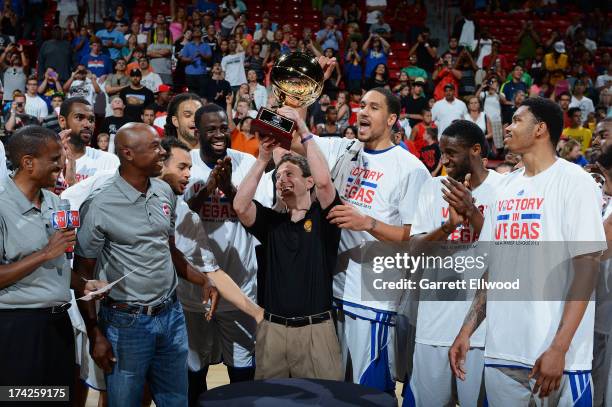 Head Coach Darren Erman of the Golden State Warriors holds up their trophy infront of the media after the game against the Phoenix Suns during NBA...