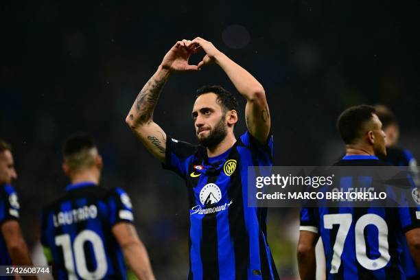 Inter Milan's Turkish midfielder Hakan Calhanoglu celebrates after scoring a penalty during the UEFA Champions League 1st round day 3 Group D...