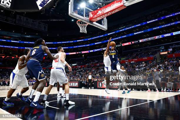 Peyton Watson of the Denver Nuggets takes a shot against the LA Clippers in the first half at Crypto.com Arena on October 17, 2023 in Los Angeles,...
