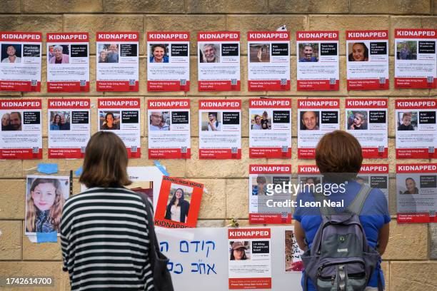 Photographs of some of those taken hostage by Hamas during their recent attacks are seen on October 18, 2023 in Tel Aviv, Israel. As Israel prepares...