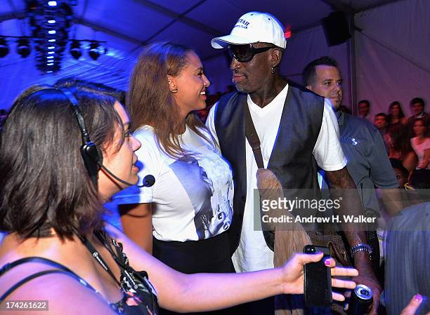 Dennis Rodman and Alexis Rodman attend the Anna Kosturova/Beach Riot/Lolli Swim/Manglar/Indah show during Mercedes-Benz Fashion Week Swim 2014 at the...