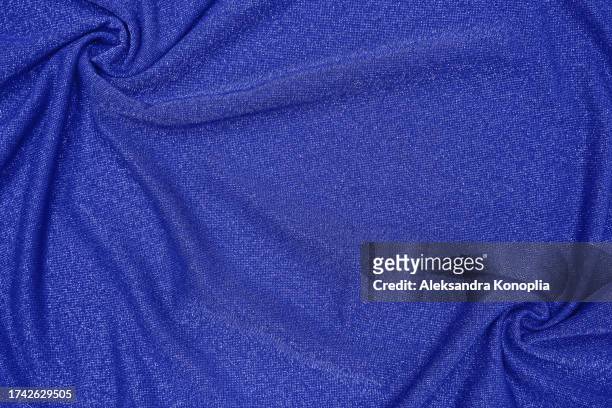 trendy 80s, 90s, 2000s background of draped dark saturated blue fabric with silver lurex thread. beautiful fashionable shiny fabric with a shiny thread for making clothes. textile background texture. - glamour live show fashion shows stock pictures, royalty-free photos & images