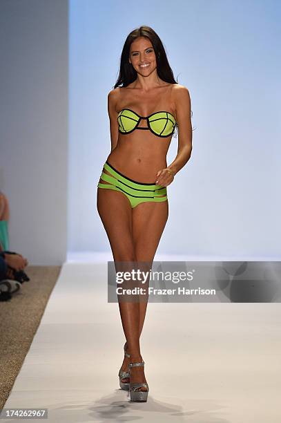 Model walks the runway at the Indah show during Mercedes-Benz Fashion Week Swim 2014 at Cabana Grande at the Raleigh on July 22, 2013 in Miami,...