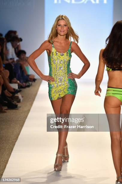 Model walks the runway at the Indah show during Mercedes-Benz Fashion Week Swim 2014 at Cabana Grande at the Raleigh on July 22, 2013 in Miami,...