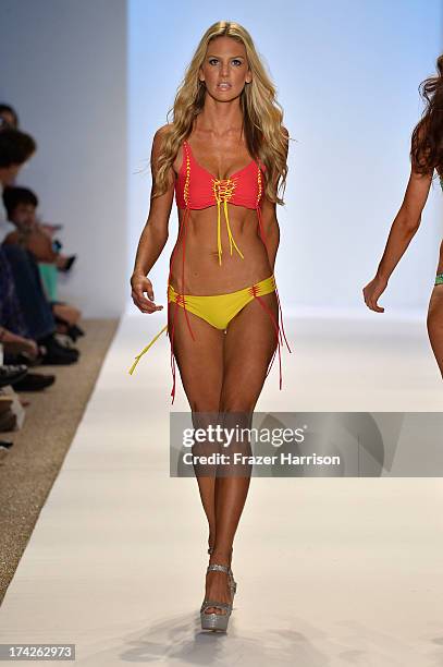 Model walks the runway at the Indah show during Mercedes-Benz Fashion Week Swim 2014 at Cabana Grande at the Raleigh on July 22, 2013 in Miami,...