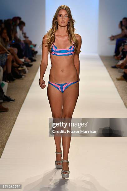 Model walks the runway at the Indah show during Mercedes-Benz Fashion Week Swim 2014 at Cabana Grande at the Raleigh on July 22, 2013 in Miami,...