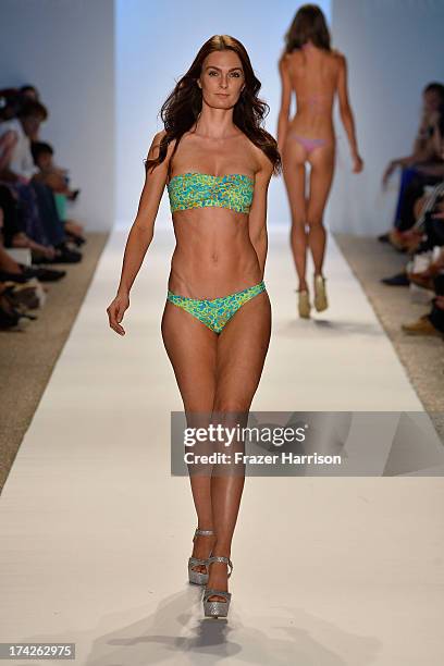 Model walks the runway at the Indah show during Mercedes-Benz Fashion Week Swim 2014 at the Raleigh on July 22, 2013 in Miami Beach, Florida.