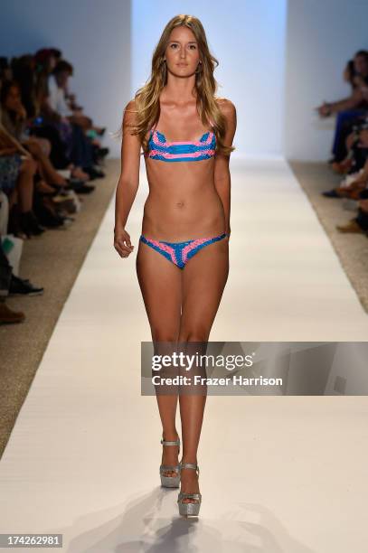 Model walks the runway at the Indah show during Mercedes-Benz Fashion Week Swim 2014 at the Raleigh on July 22, 2013 in Miami Beach, Florida.