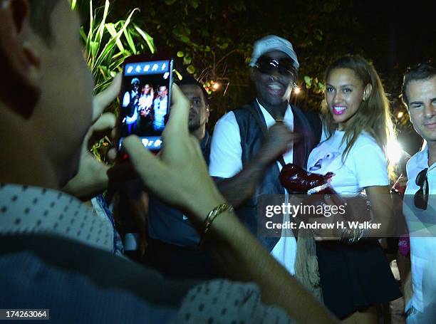 Dennis Rodman and Alexis Rodman attend the Anna Kosturova/Beach Riot/Lolli Swim/Manglar/Indah show during Mercedes-Benz Fashion Week Swim 2014 at the...