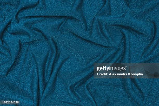 trendy 80s, 90s, 2000s background of draped dark emerald green, turquoise mint fabric with silver lurex thread. beautiful fashionable shiny fabric with a shiny thread for making clothes. textile background texture. - glamour live show fashion shows stock pictures, royalty-free photos & images
