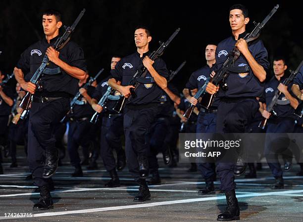 Members of the Algerian police forces parade during the festivities marking the fiftieth anniversary of the General Directorate of National Security...