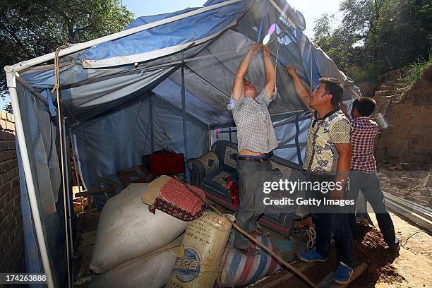 Local residents set up a tent at Lalu village on July 22, 2013 in Minxian, China. At least 89 people were killed and 5 others missing after a...