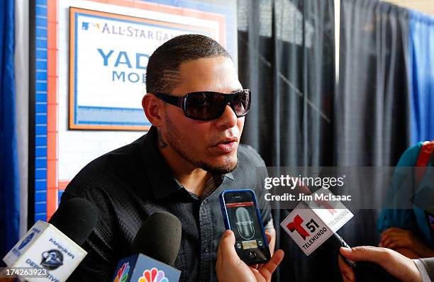 Yadier Molina of the St. Louis Cardinals answers questions during media availability prior to All-Star Workout Day on July 15, 2013 at Citi Field in...