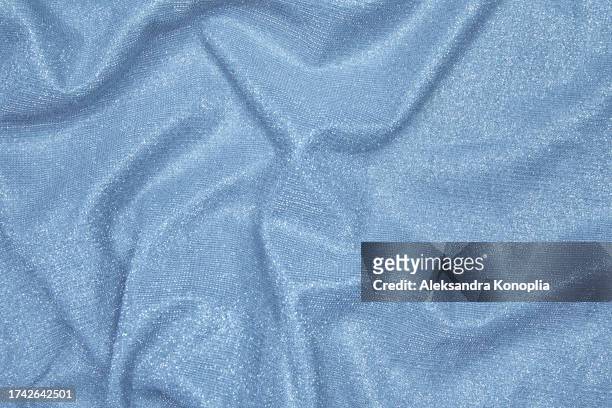 trendy 80s, 90s, 2000s background of draped light blue fabric with silver lurex thread. beautiful fashionable shiny fabric with a shiny thread for making clothes. textile background texture. - glamour live show fashion shows stock pictures, royalty-free photos & images