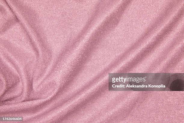 trendy 80s, 90s, 2000s background of draped dusty pink fabric with silver lurex thread. beautiful fashionable shiny fabric with a shiny thread for making clothes. textile background texture. - glamour live show fashion shows stock pictures, royalty-free photos & images