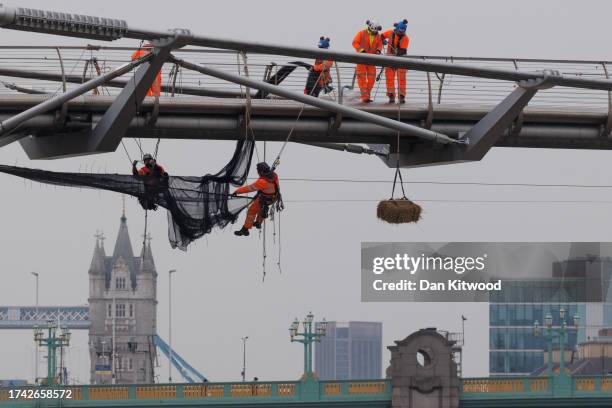 Owing to a by-law, a hay bail hangs under Millennium Bridge as work continues on October 18, 2023 in London, England. The by-law in question is 36.2...