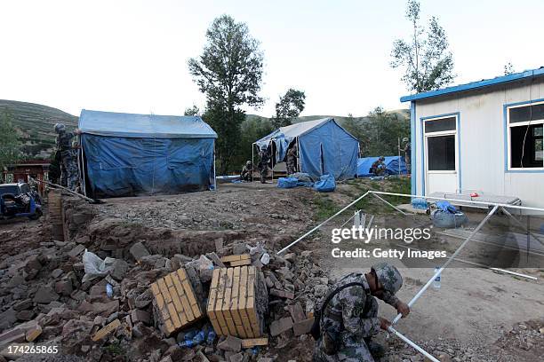 Rescuers set up crisis tents in Yongguang village on July 22, 2013 in Minxian, China. At least 89 people were killed and 5 others missing after a...