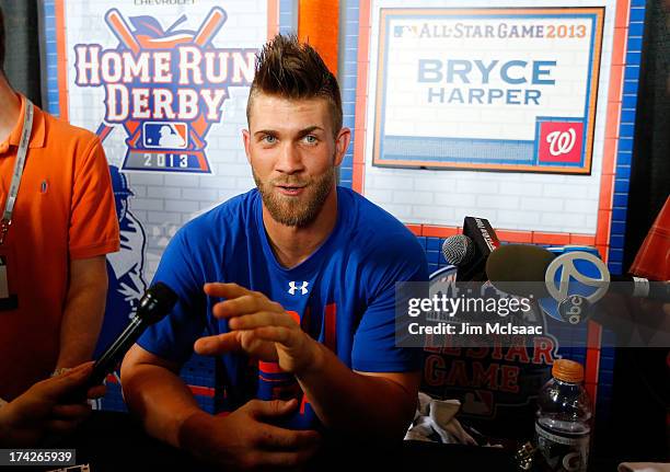 Bryce Harper of the Washington Nationals answers questions during media availability prior to All-Star Workout Day on July 15, 2013 at Citi Field in...