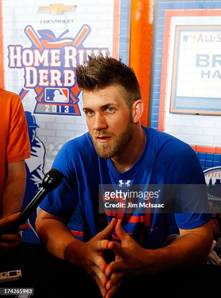 Bryce Harper of the Washington Nationals answers questions during media availability prior to All-Star Workout Day on July 15, 2013 at Citi Field in...