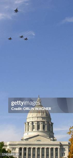 Military F-15's flyover the state capitol building in honor of Missouri Governor Mel Carnahan, following a memorial service 20 October in Jefferson...