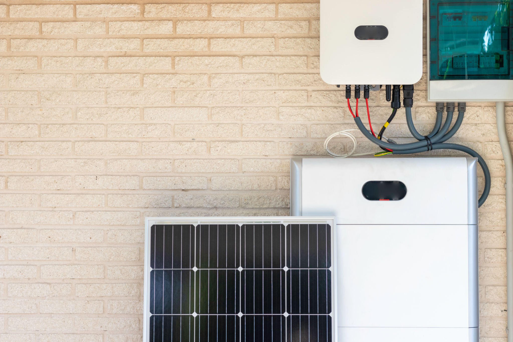 Front view of photovoltaic panel and battery instalation leaning on the beige white wall with no people renewable energy Front view of photovoltaic panel and battery instalation leaning on the beige white wall with no people renewable energy