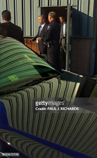 Republican presidental candidate and Texas Governor George W. Bush exits Visioneering Incorporated Headquarters through a back door after delivering...