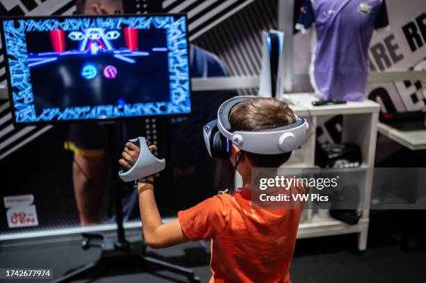 Young boy playing with Meta Quest 2 all-in-one VR headset during ZGamer, a festival of video games, digital entertainment, board games and YouTubers...
