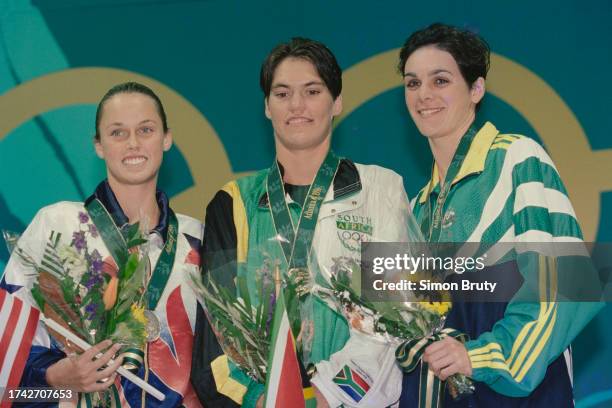 Penny Heyns from South Africa celebrates winning the gold medal in the Women's 100 metre Breaststroke competition with silver medalist Amanda Beard...