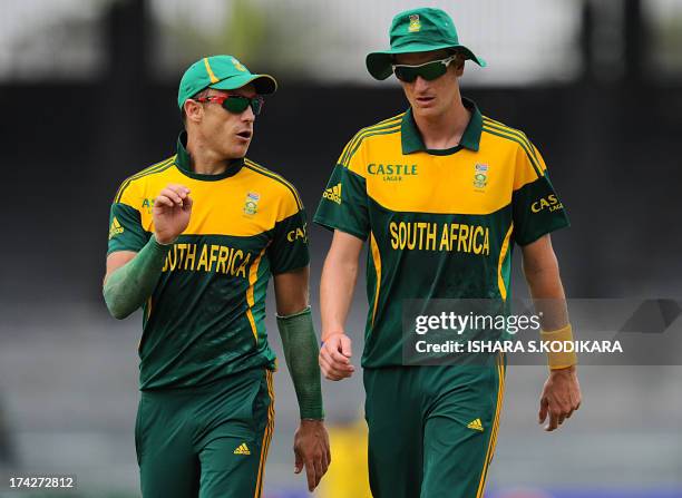 South African cricketer Faf du Plessis talks to Chris Morris during the second One Day International match between Sri Lanka and South Africa at the...