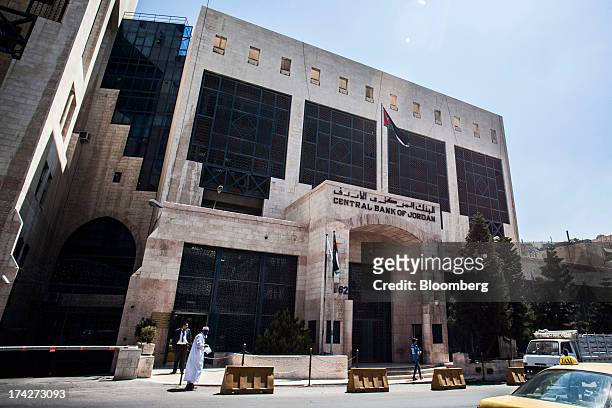 Pedestrians pass the Central Bank of Jordan in Amman, Jordan, on Sunday, July 21, 2013. Jordanian internal debt has reached 11.862 dinars, external...