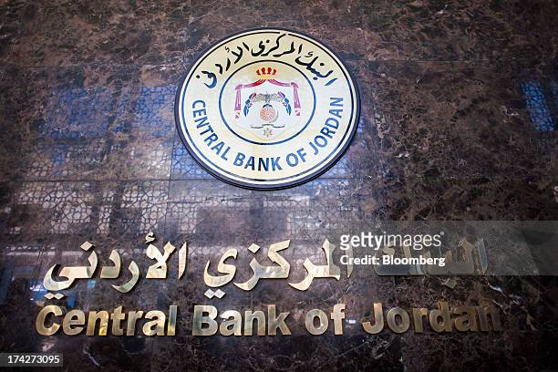 The logo sits on display outside the Central Bank of Jordan in Amman, Jordan, on Sunday, July 21, 2013. Jordanian internal debt has reached 11.862...