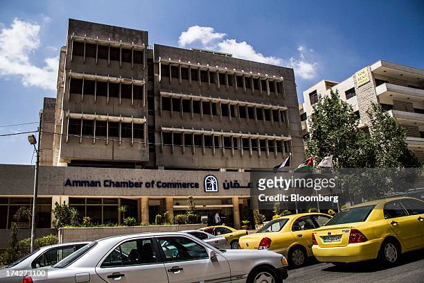 Automobiles pass the Amman Chamber of Commerce in the financial district in Amman, Jordan, on Sunday, July 21, 2013. Jordanian internal debt has...