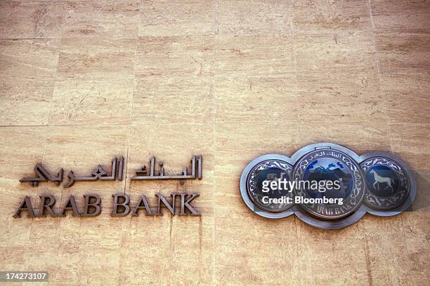The logo sits on display outside the headquarters of Arab Bank Plc in the financial district in Amman, Jordan, on Sunday, July 21, 2013. Jordanian...